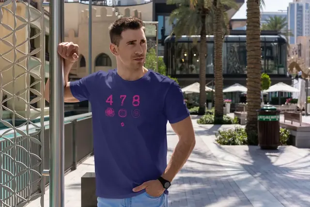 Man wearing a purple Blue Eli 4-7-8 t-shirt