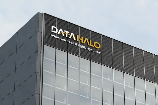 Data Halo logo as a gold sign on a glass office building