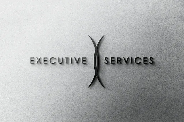 Executive Services logo as a dark sign on a light wall