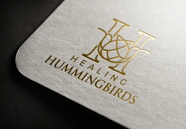Healing Hummingbirds logo in gold foil on cream paper