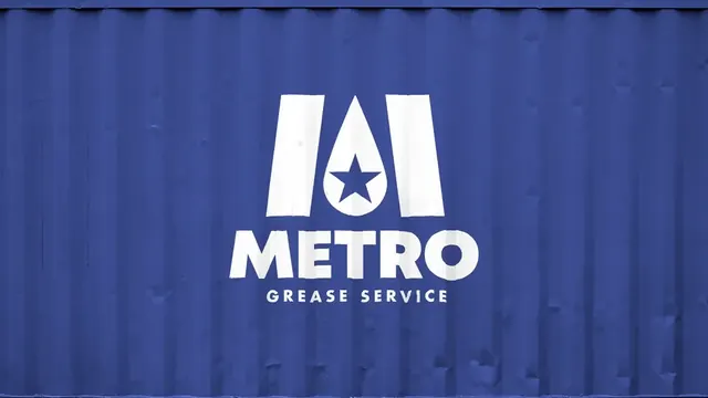 Metro Grease Service logo on a blue shipping container