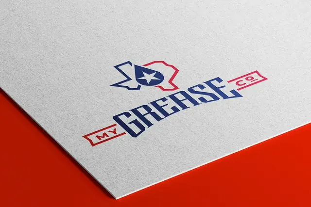 My Grease Co. logo embossed on white paper over a red surface