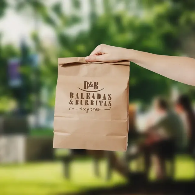 Hand holding a Baleadas & Burritas Express kraft paper bag