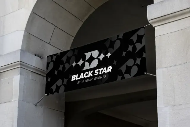 Black Star Strategic Events patterned banner hanging under a stone arch