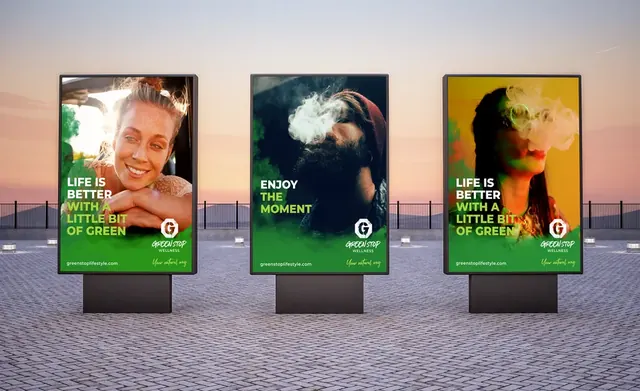 Three Green Stop Wellness street-level display posters at sunset