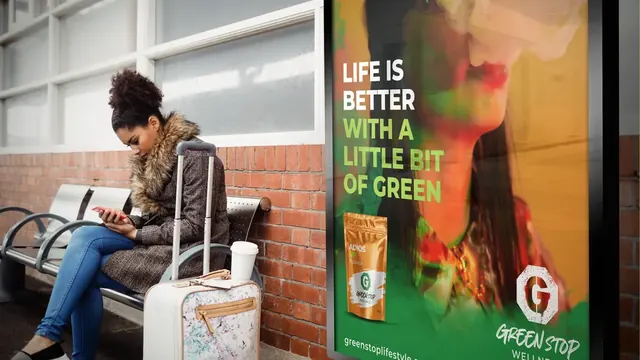 Green Stop Wellness poster in a transit waiting area