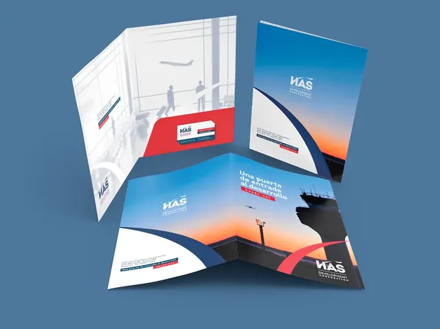 HASDC presentation folders and business card on a blue surface