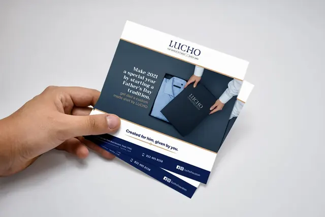 Hand holding a square Lucho Father's Day flyer