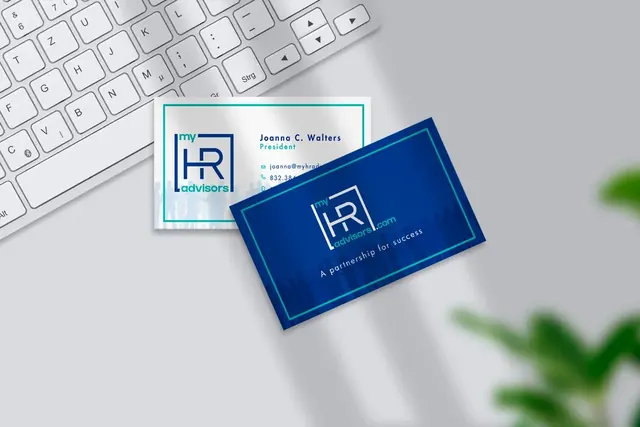 My HR Advisors business cards on a desk next to a keyboard