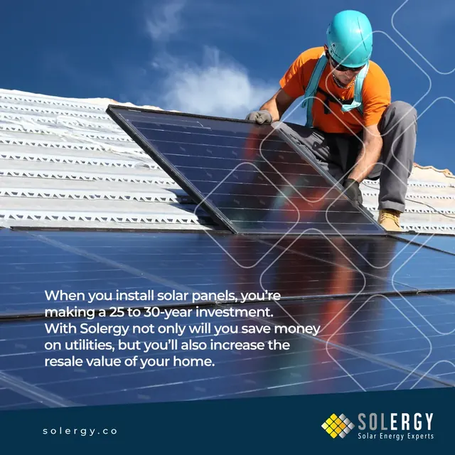 Solergy solar energy post with an installer fitting a solar panel on a roof