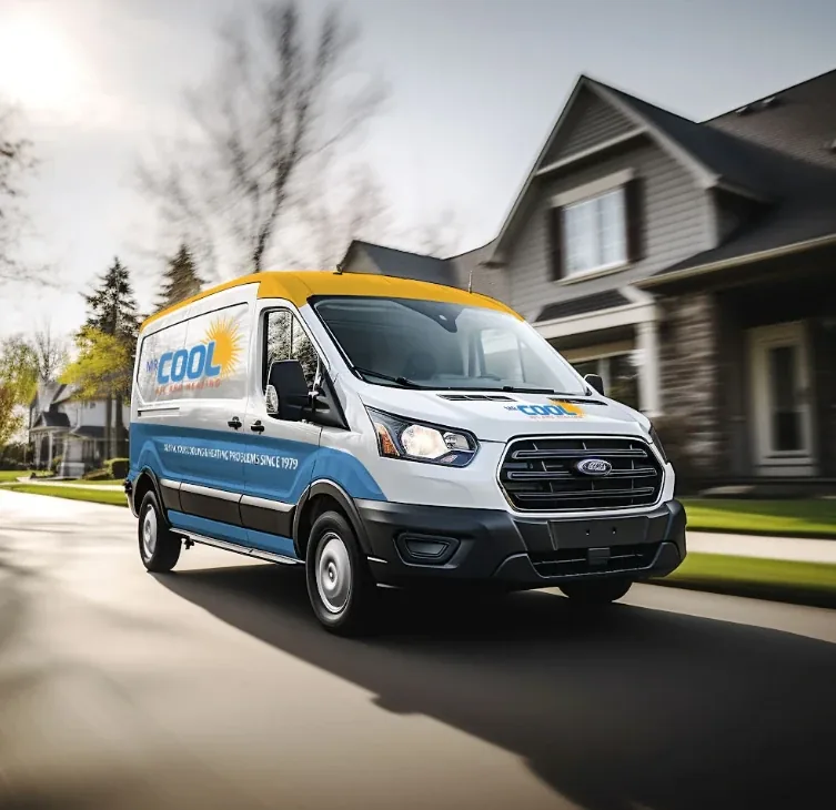 Mr. Cool A/C and Heating branded van driving down a residential street