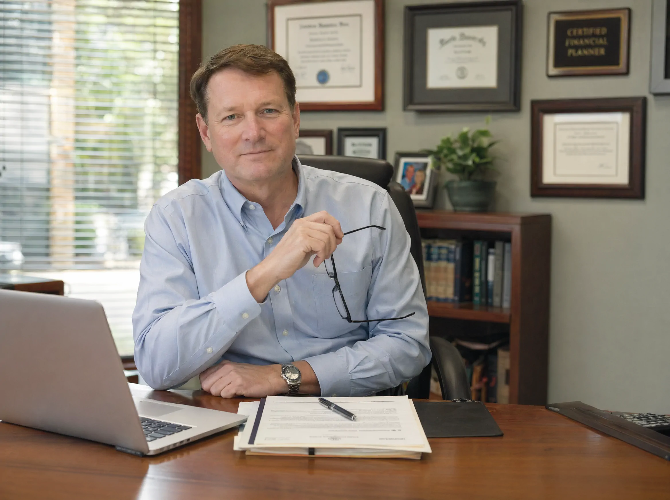 Houston tax preparation and financial advisor business owner in his neighborhood office